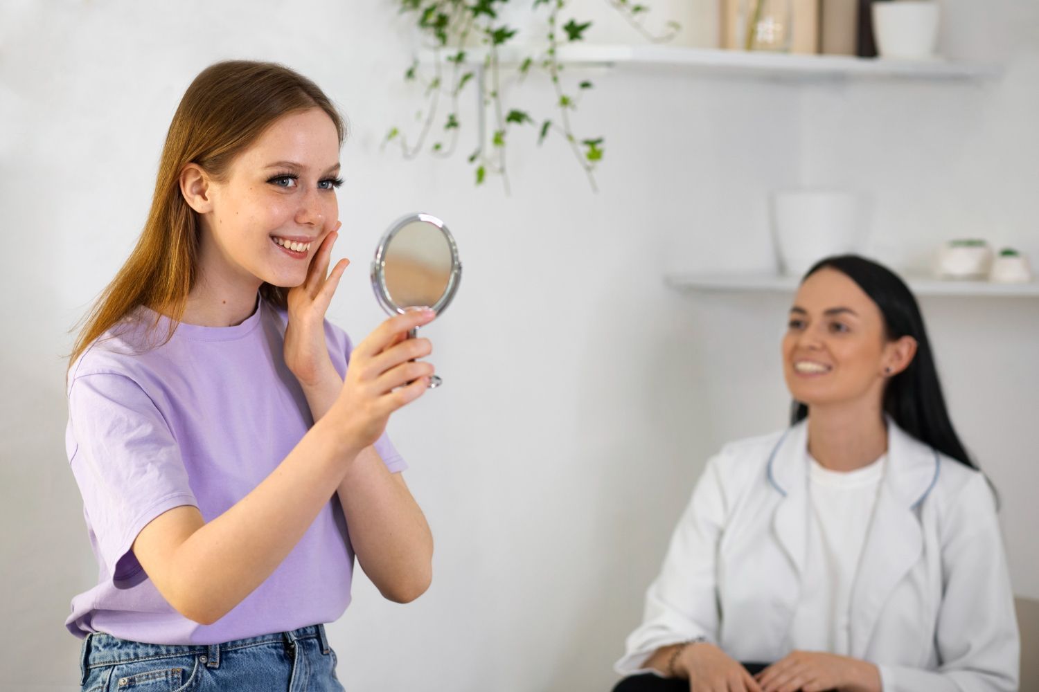 A woman is looking at her face in a mirror while a doctor looks on.