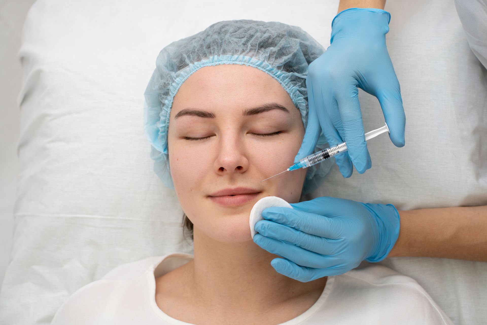 A woman is getting a botox injection in her face.