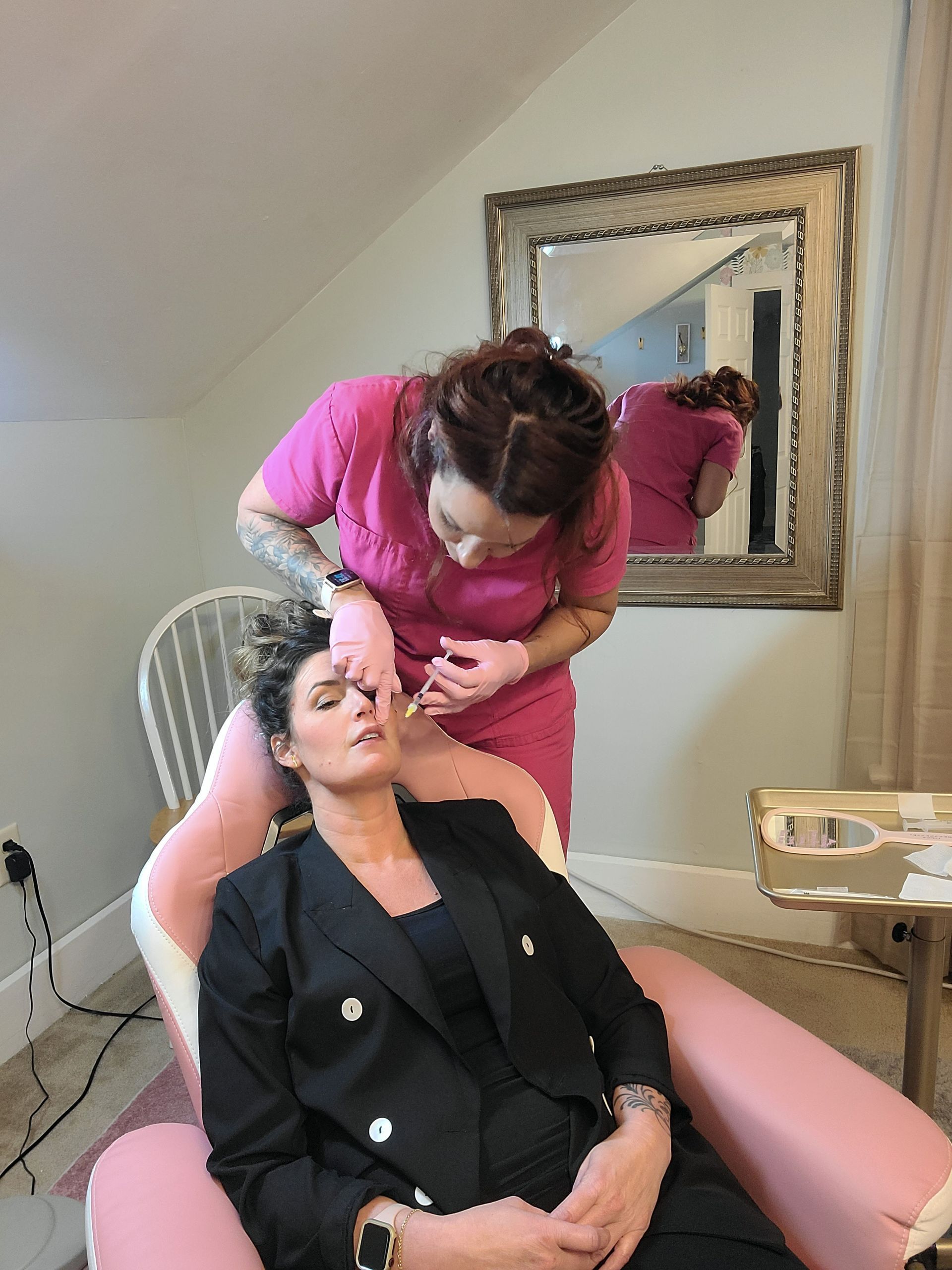 A woman is getting a botox injection in her face while sitting in a chair.