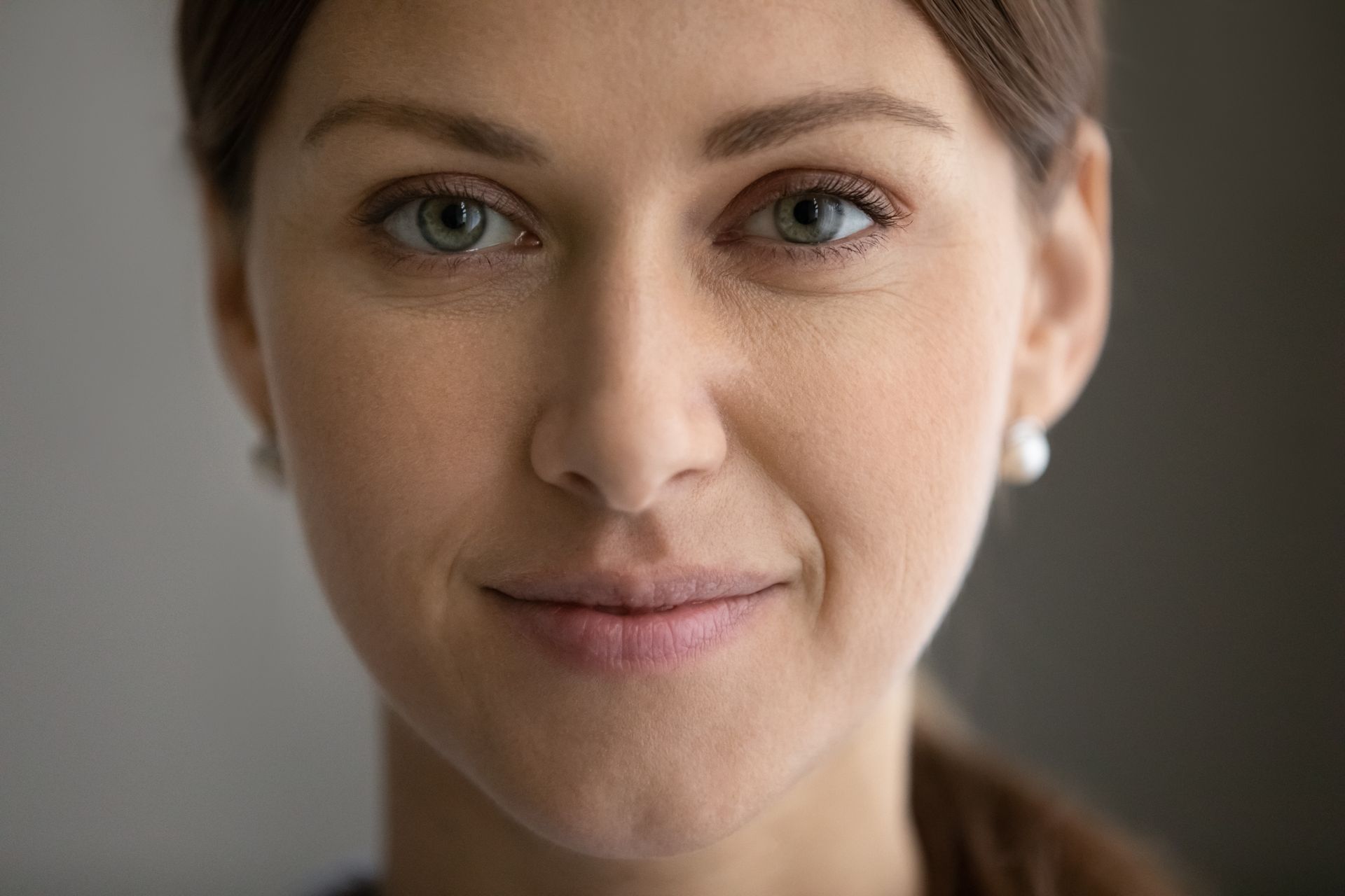 A close up of a woman 's face with a smile on her face.
