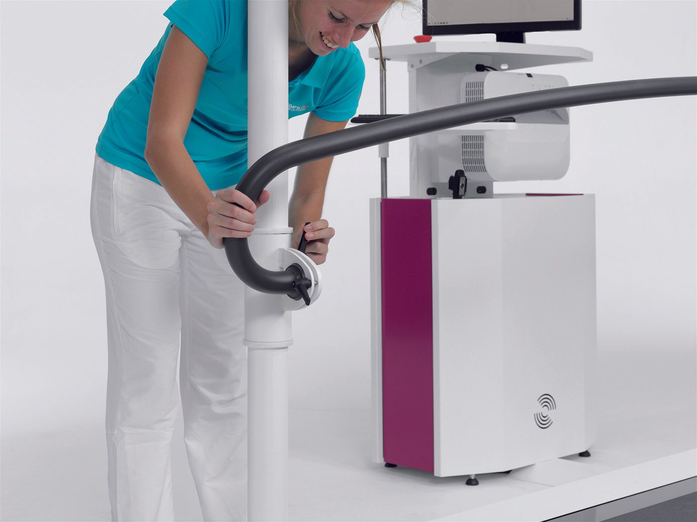 A woman in a blue shirt is working on a machine