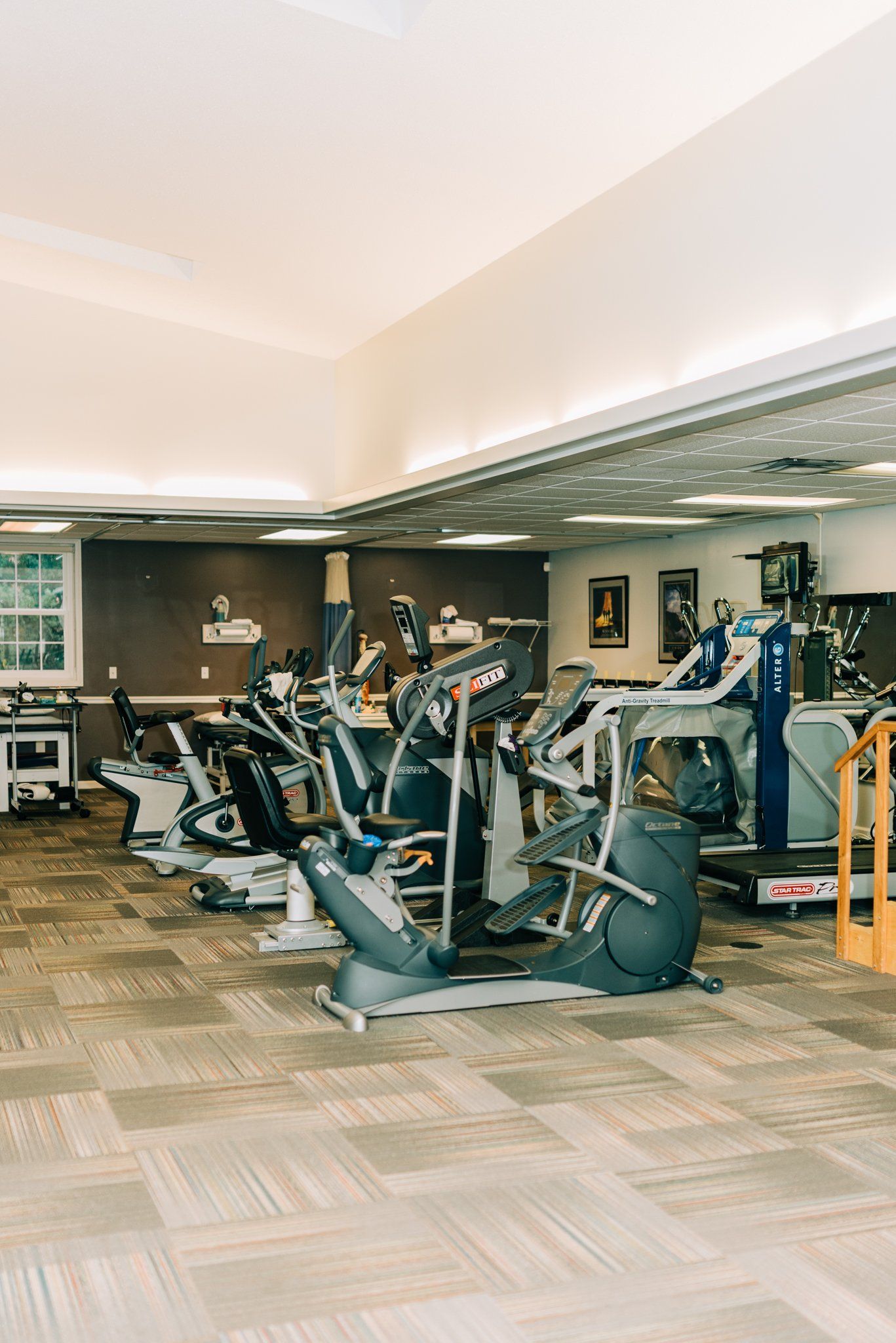 A gym filled with a variety of exercise equipment.