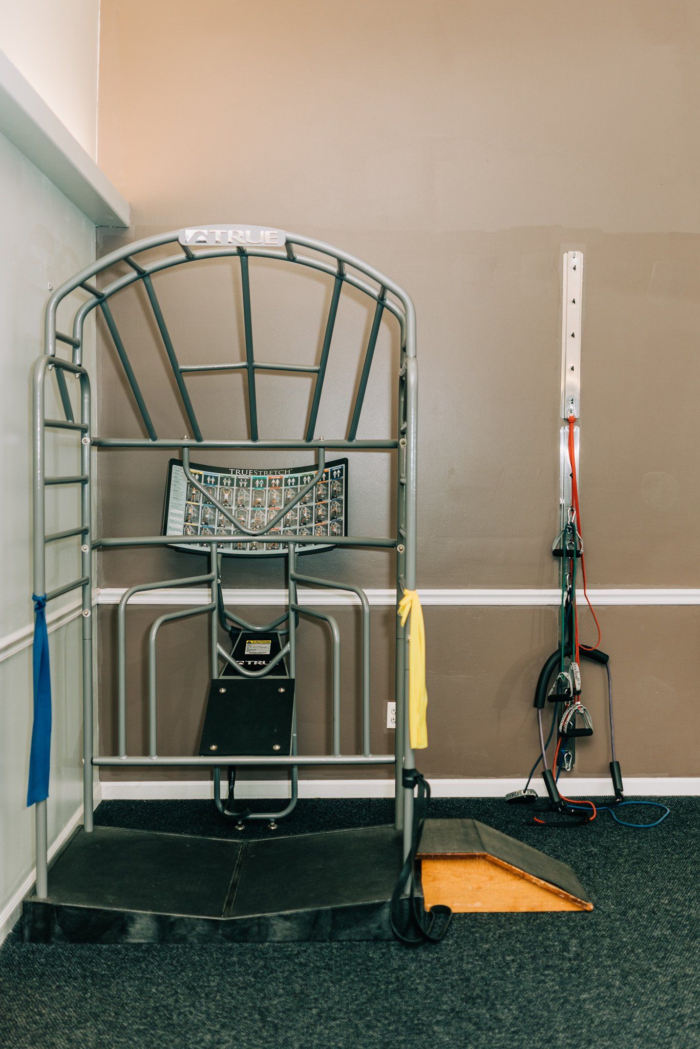 A room with a bunch of exercise equipment in it.