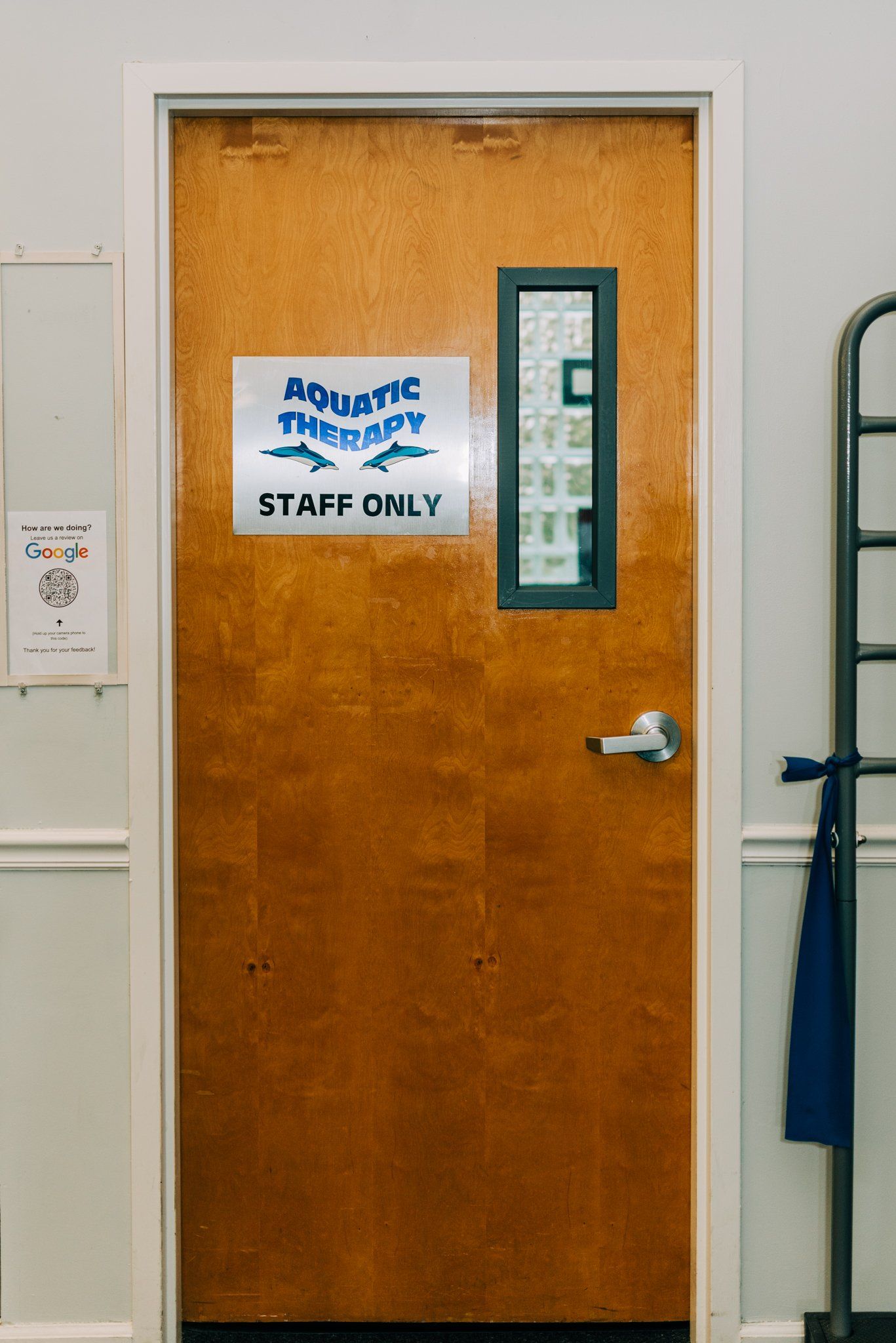 A wooden door with a sign on it that says aquatic therapy staff only.