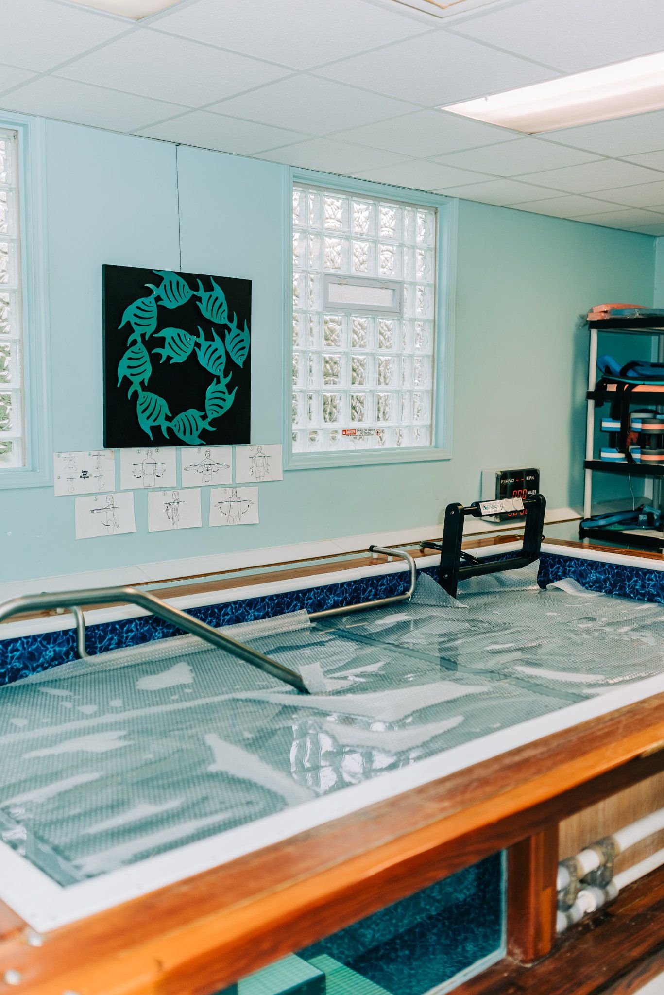 There is a large swimming pool in the middle of a room.