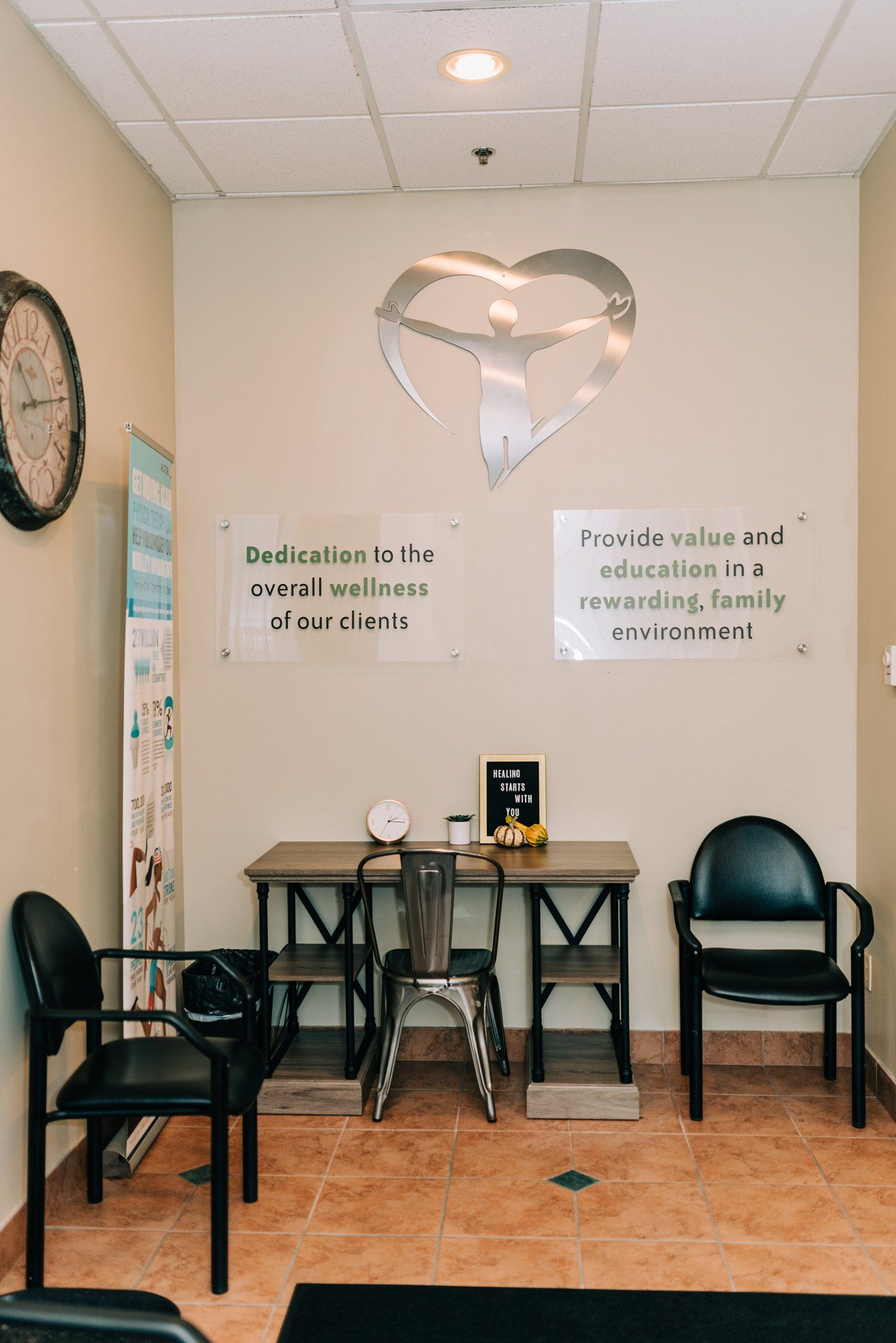 A waiting room with chairs and a clock on the wall