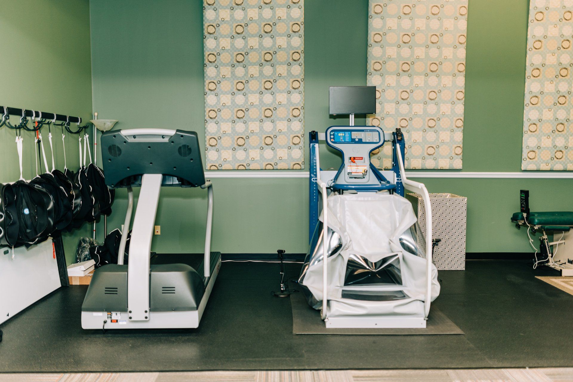 There is a treadmill and a chair in the room.
