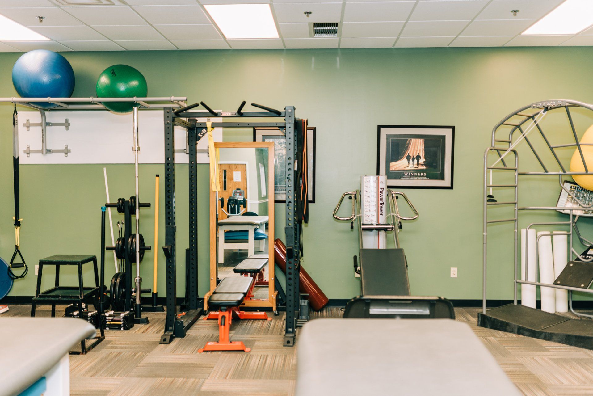 There are many different types of exercise equipment in this room.