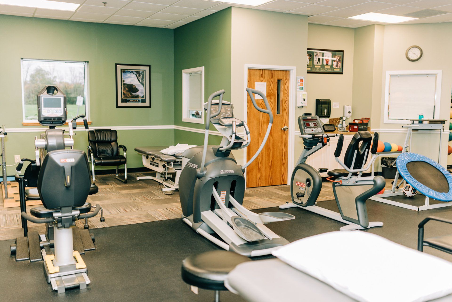 There are many different types of exercise equipment in this room.