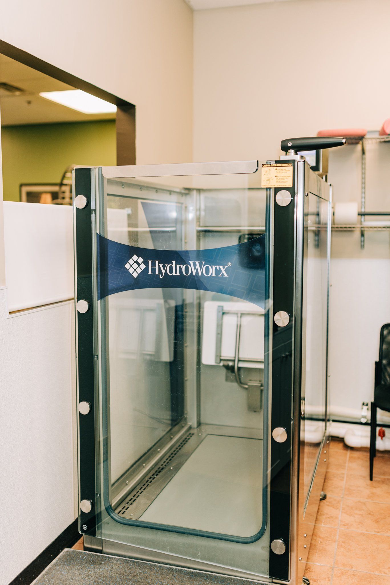 A room with a glass door and a sign that says hydroflex
