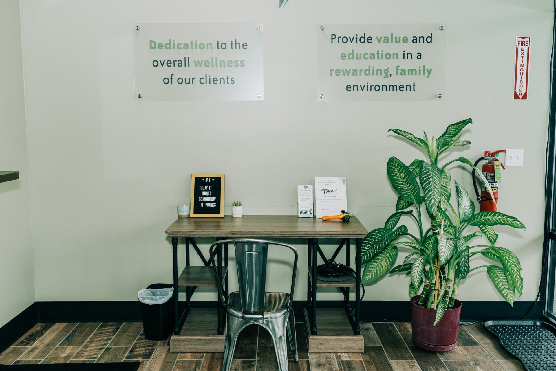 There is a table and chairs in the lobby of a dental office.