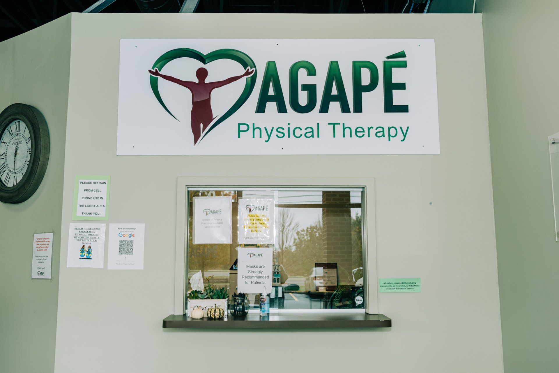 A physical therapy office with a window and a sign on the wall.