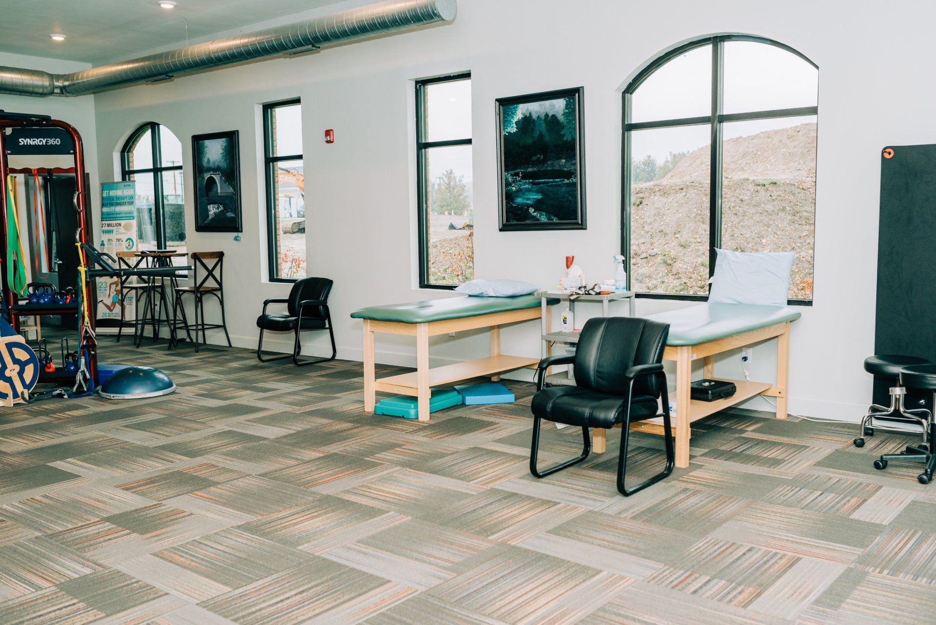 There are two tables and chairs in the room.