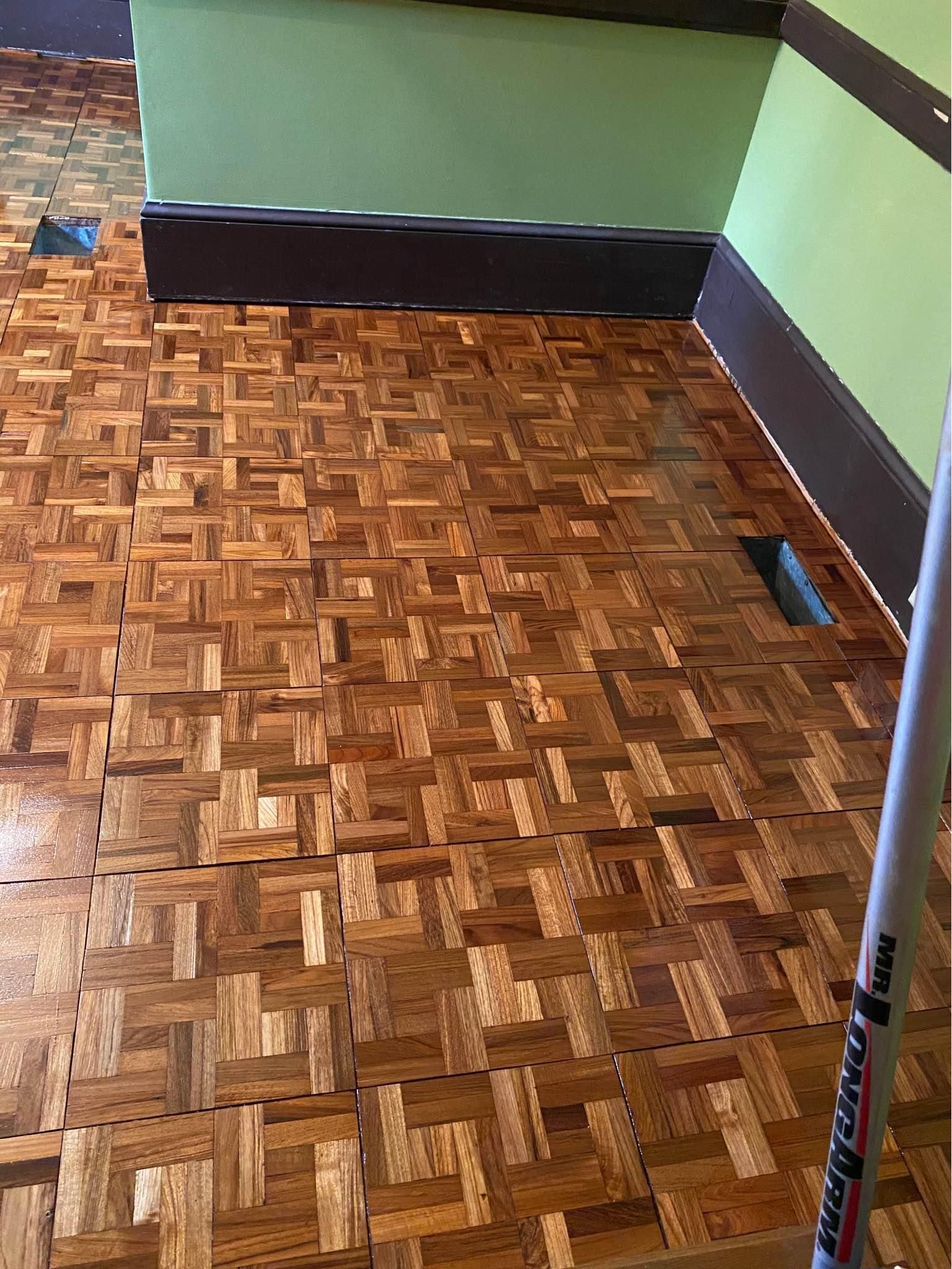 A close up of a wooden floor in a room.