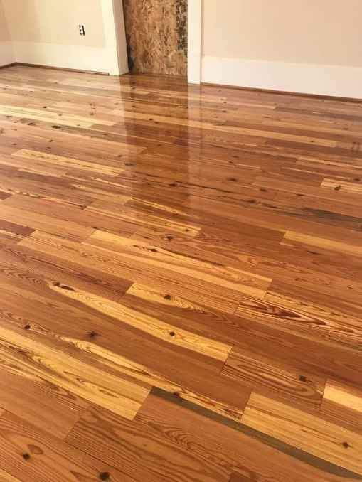 A room with a wooden floor and a door.