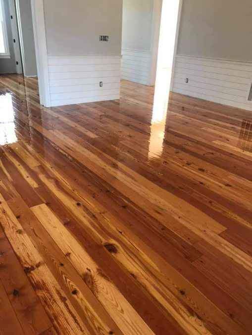 A living room with hardwood floors and white walls.