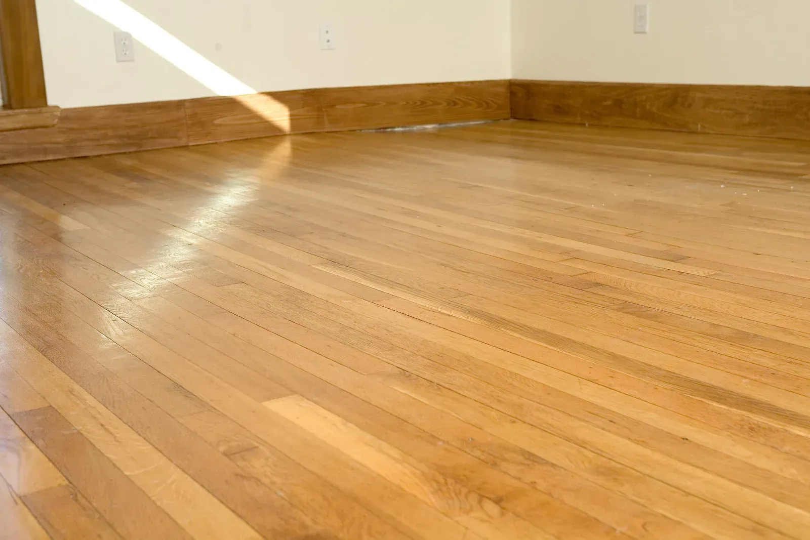 A room with a wooden floor and white walls