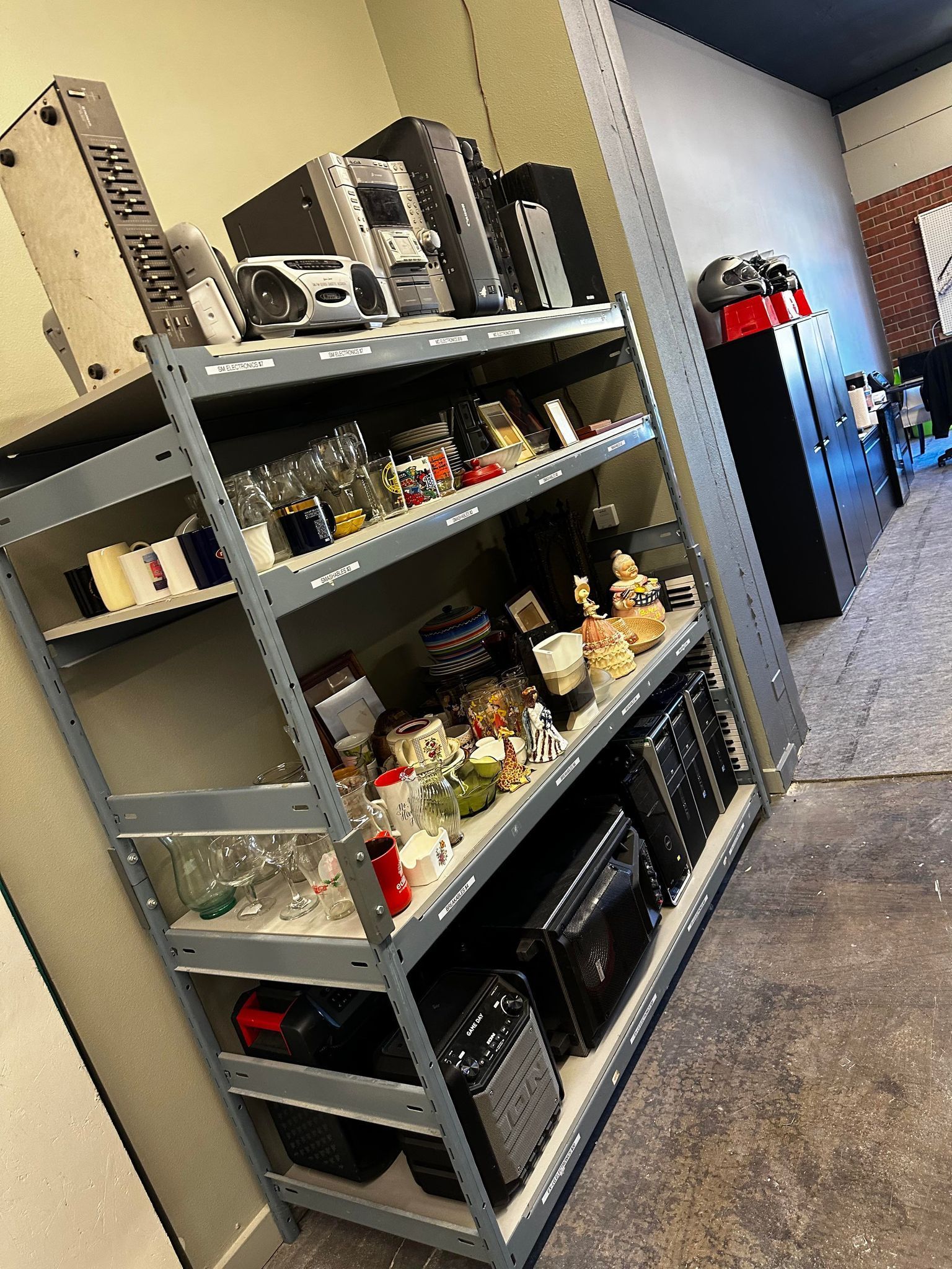 A shelf filled with lots of items in a room.