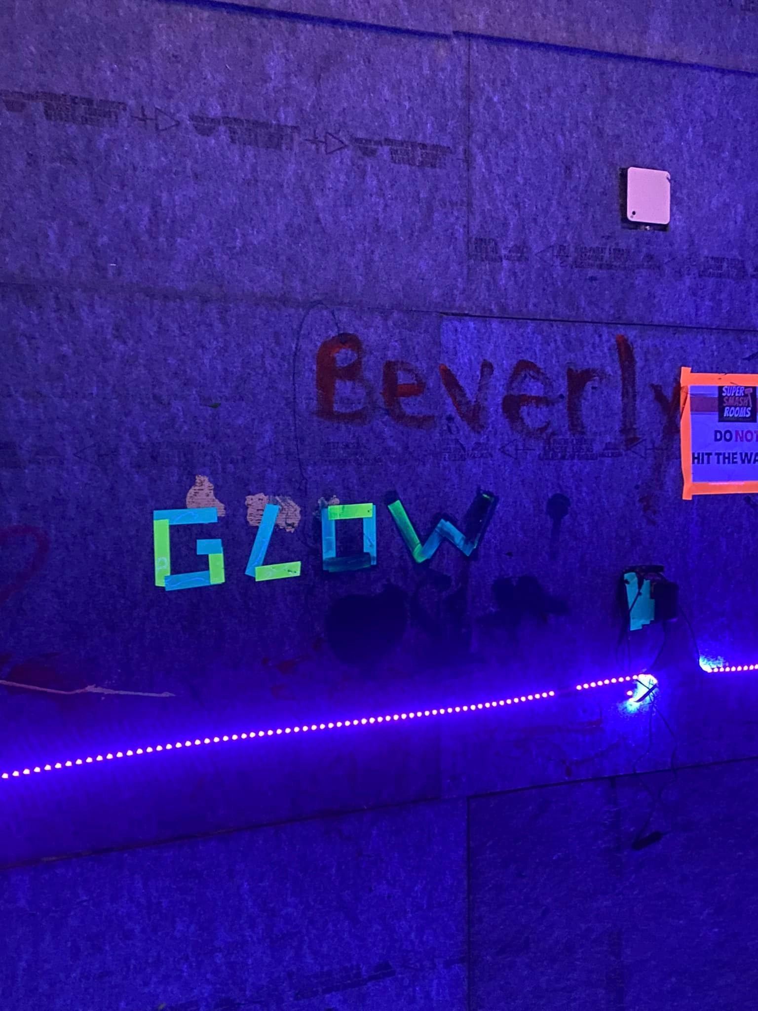 A wall with glow in the dark letters on it.
