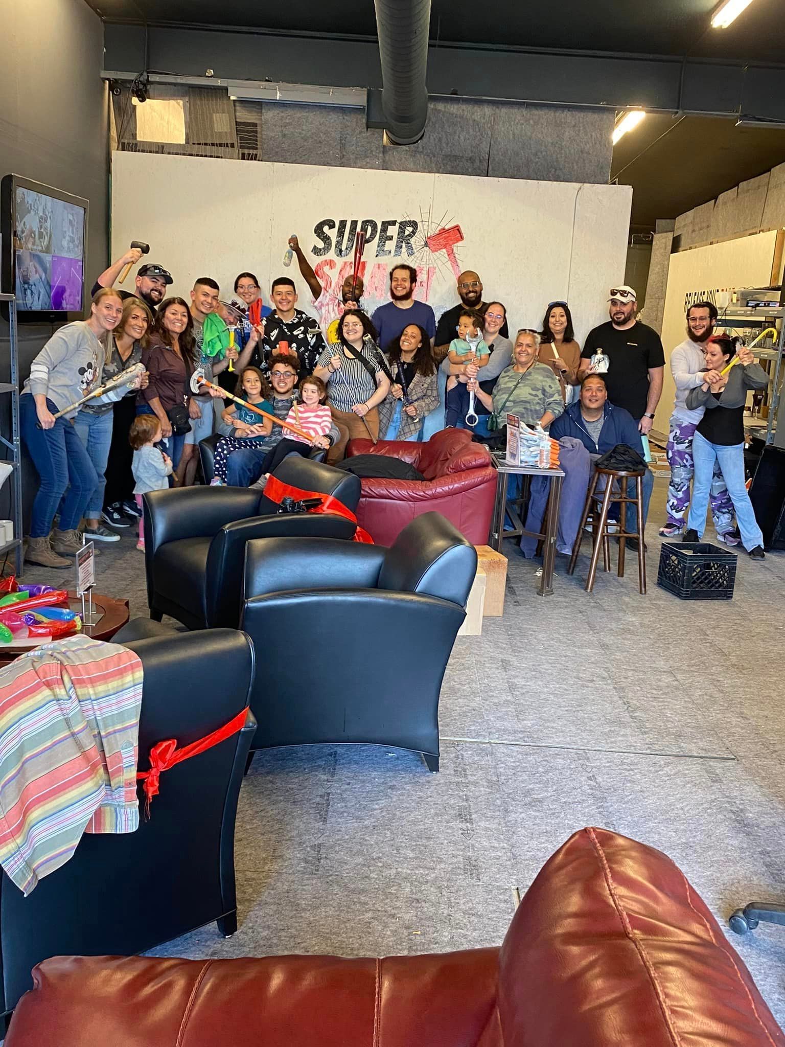 A group of people are posing for a picture in a living room.