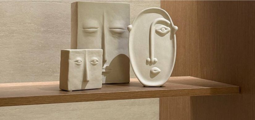 A doctor in a white coat holds a 3D digital model of the male reproductive and urinary system in their open hands.