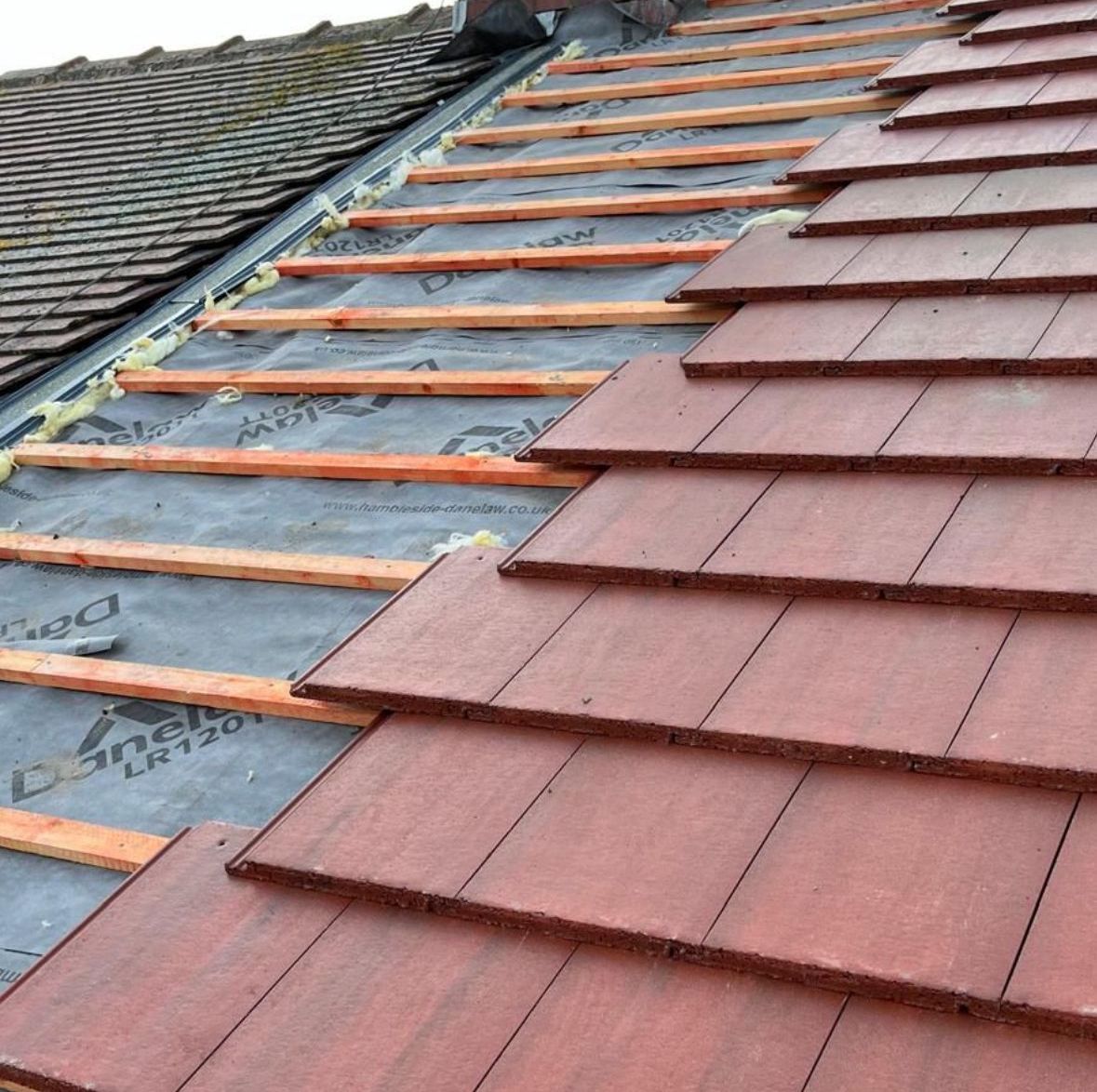 Photo of an A. Armstrong Roofing installation, featuring red roofing tiles.