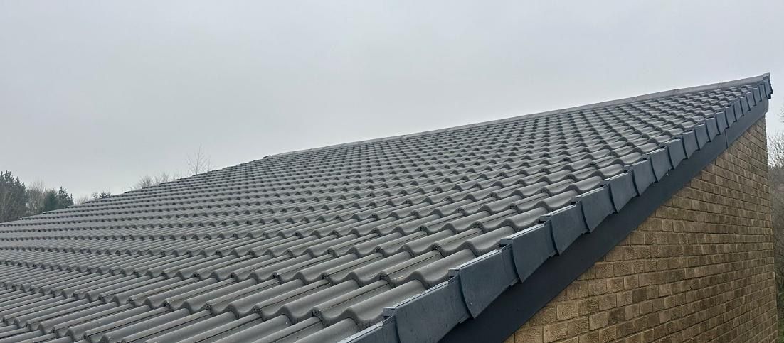 Freshly installed grey tiles on a repaired roof in Washington