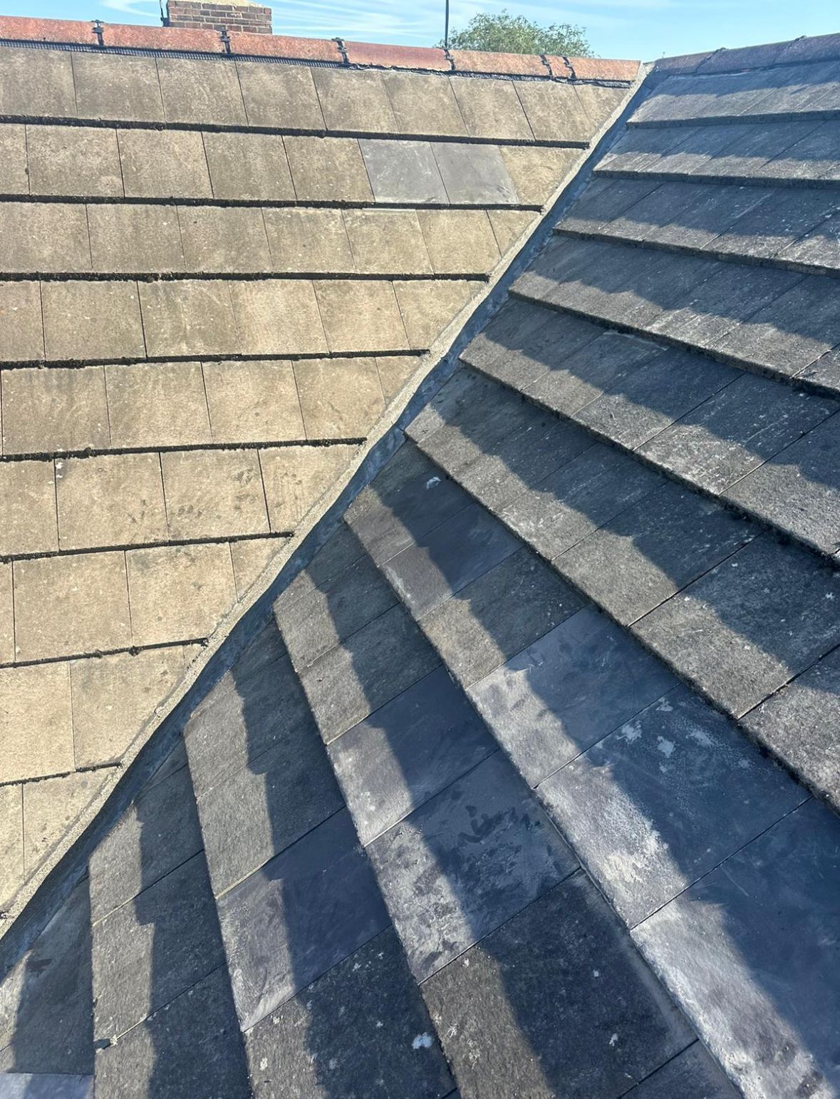 Close-up of a repaired valley section between two tiled roof slopes, showing clean lines and sealed joints.
