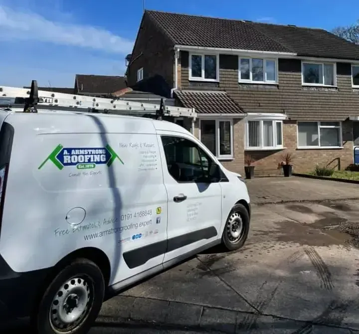 A. Armstrong Roofing van in front of a property with a new roof.