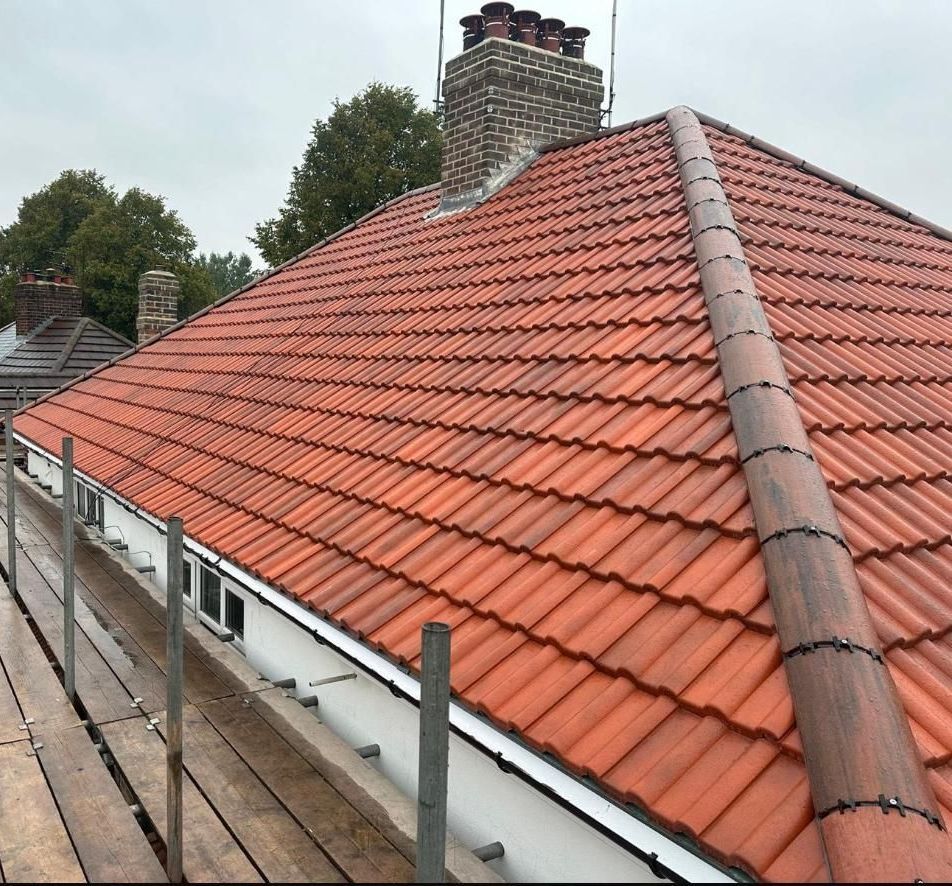 A recently completed concrete tile roof installation by A. Armstrong Roofing, showcasing durability and a sleek, professional finish. Perfect for long-lasting protection and a modern look.