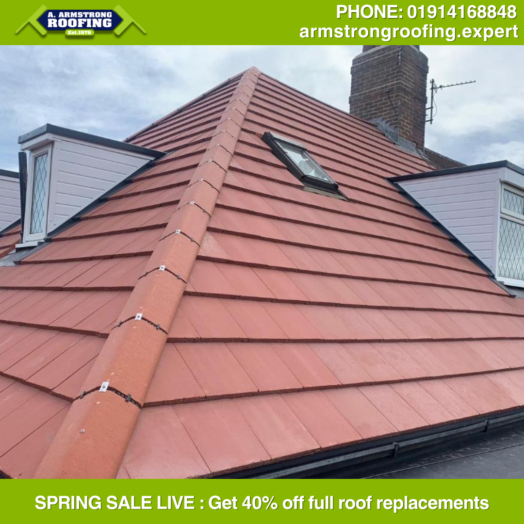 Terracotta tiled pitched roof with brick chimney, showcasing Armstrong Roofing’s high-quality finish and craftsmanship.
