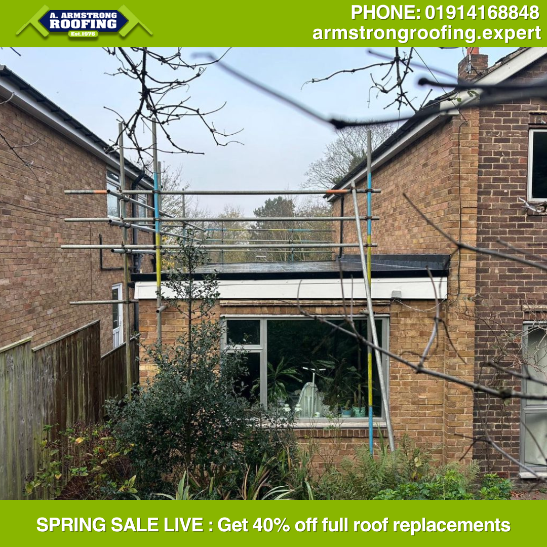 Scaffolding setup in place for pitched roof replacement on a brick house