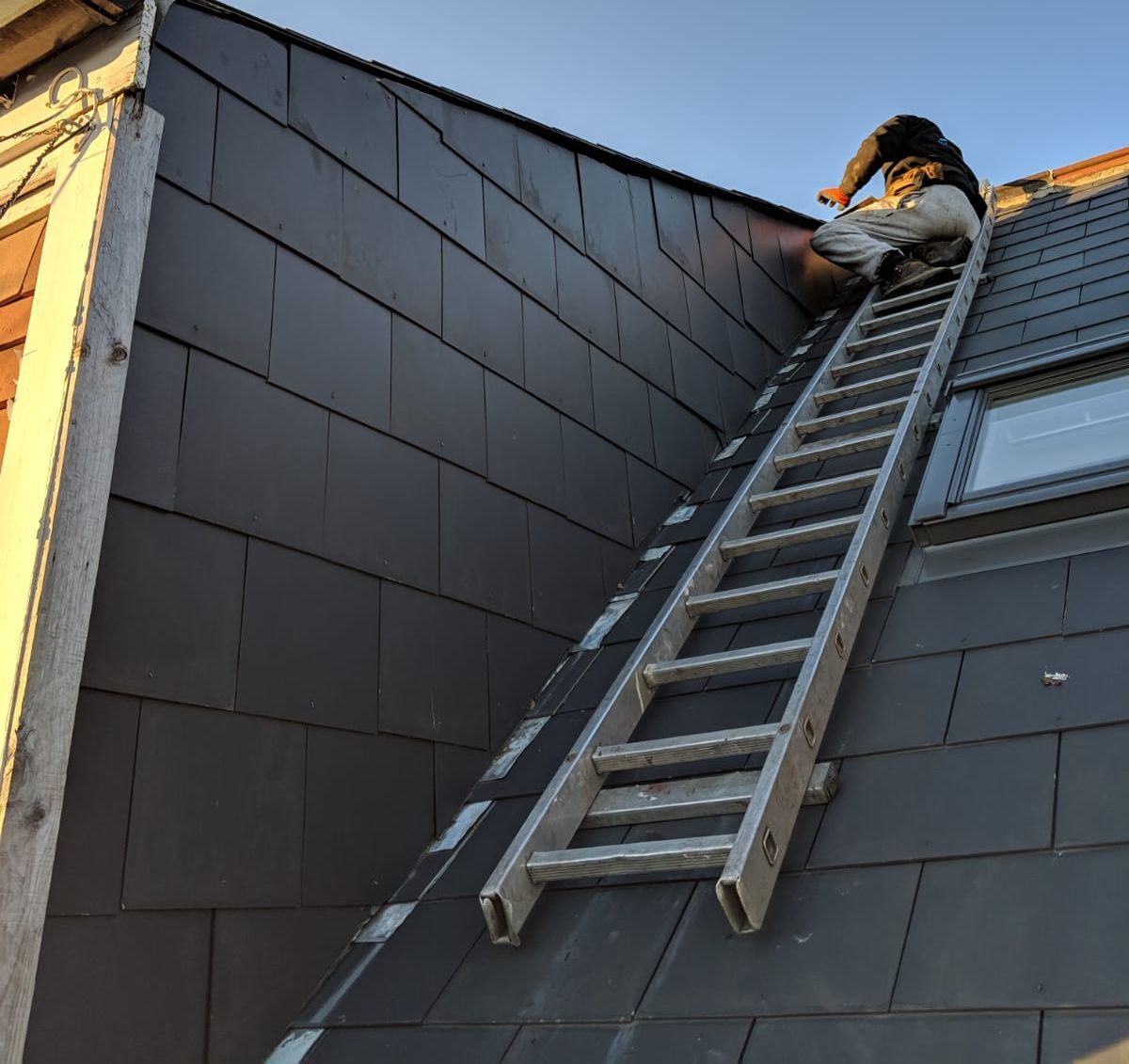 A. Armstrong Roofing team member working on a roof.