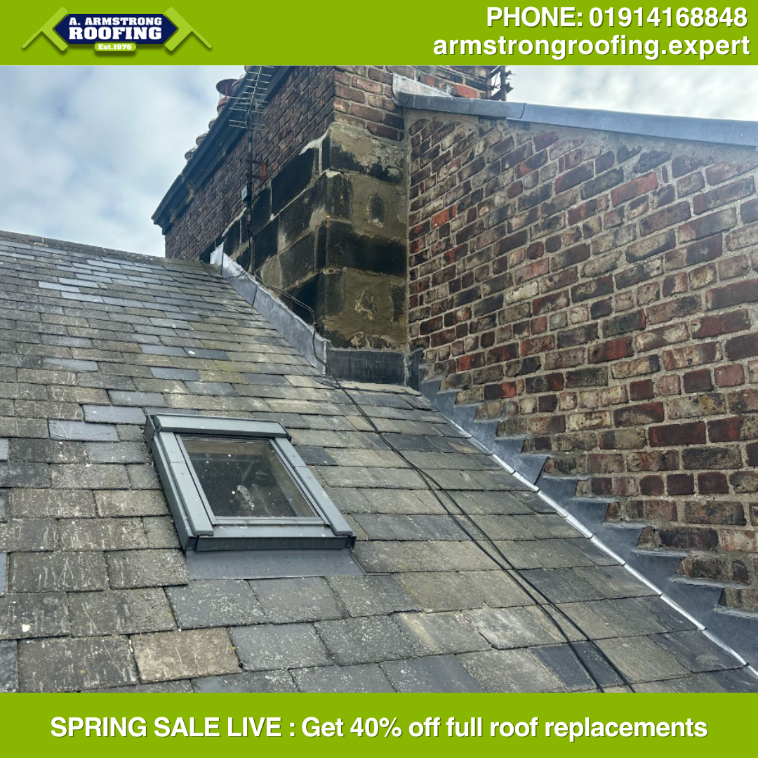 Completed chimney repair with new flashing on tiled roof