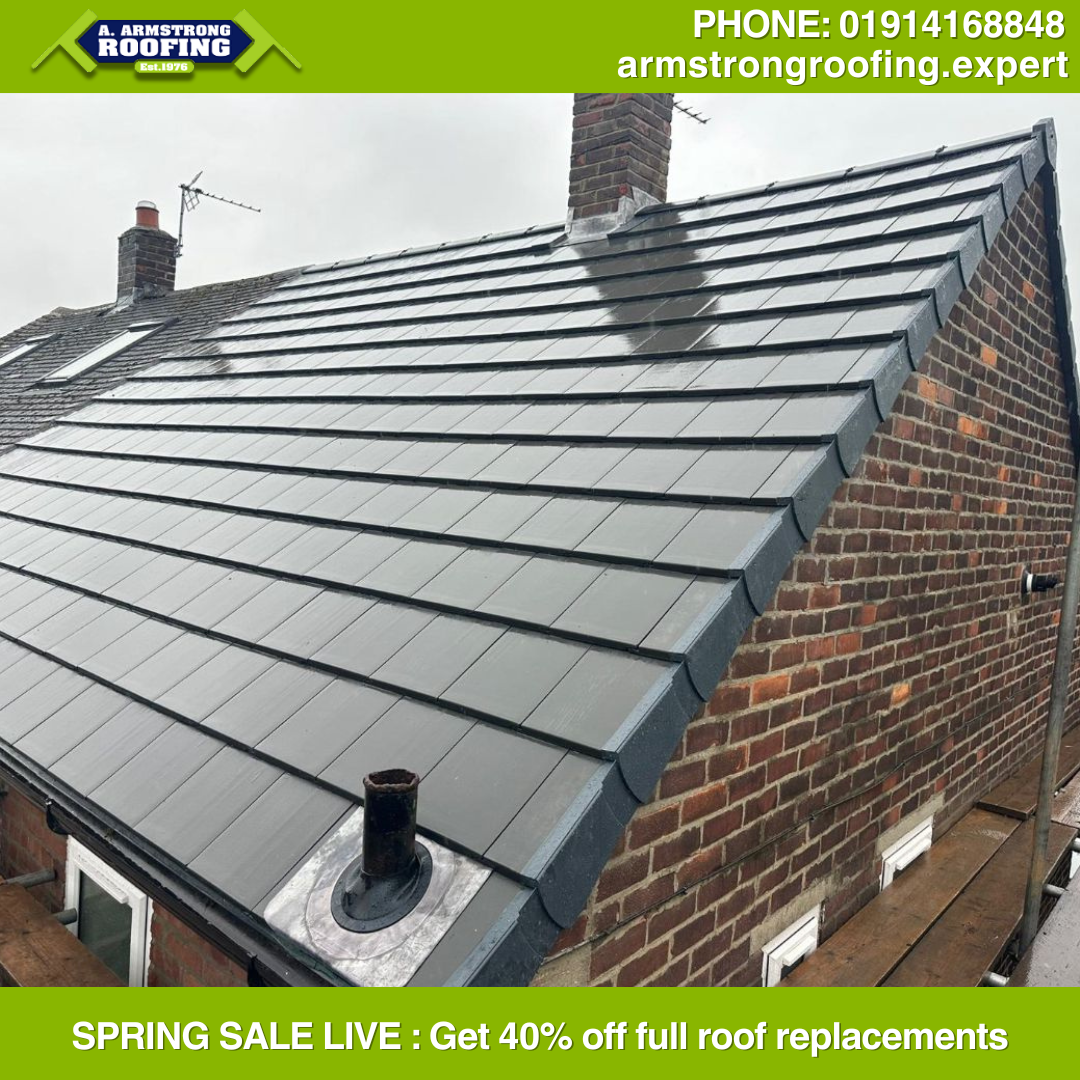 Completed roof replacement showcasing neat, modern grey tiles with updated chimney flashing and ridge caps, professionally installed by Armstrong Roofing.