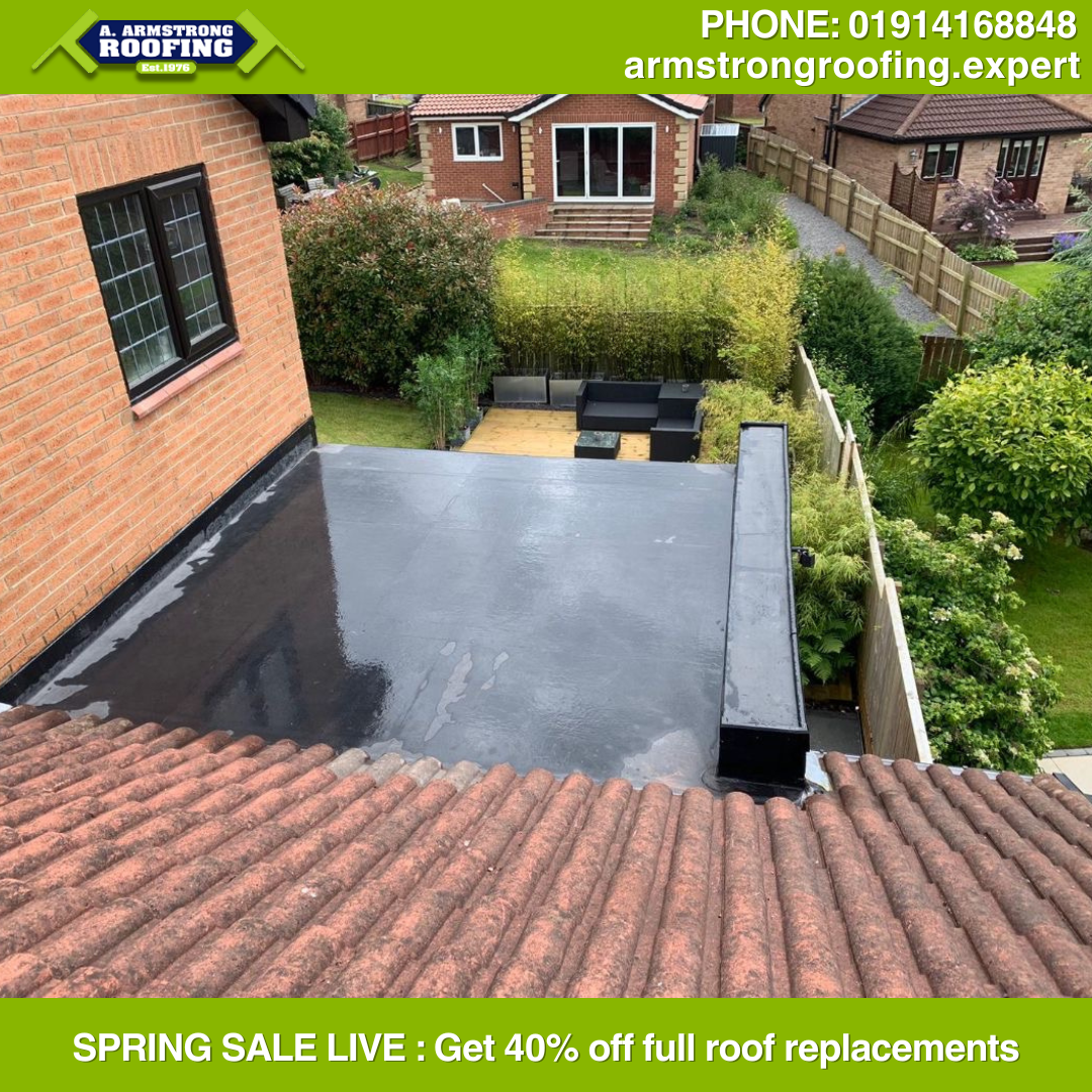 Aerial view of a newly installed flat roof with smooth, waterproof EPDM material providing durable protection, completed by Armstrong Roofing.