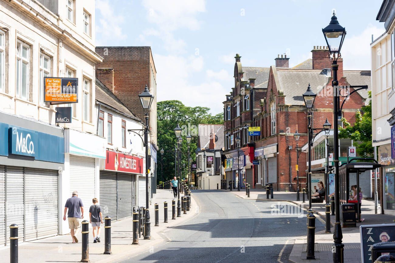 View of Newbottle Street in Houghton-le-Spring town centre, showing local shops and pedestrian area near roofing service locations covered by A. Armstrong Roofing.