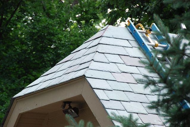 Corner section of a roof with natural slate tiles, highlighting the precise craftsmanship and elegant, durable finish.