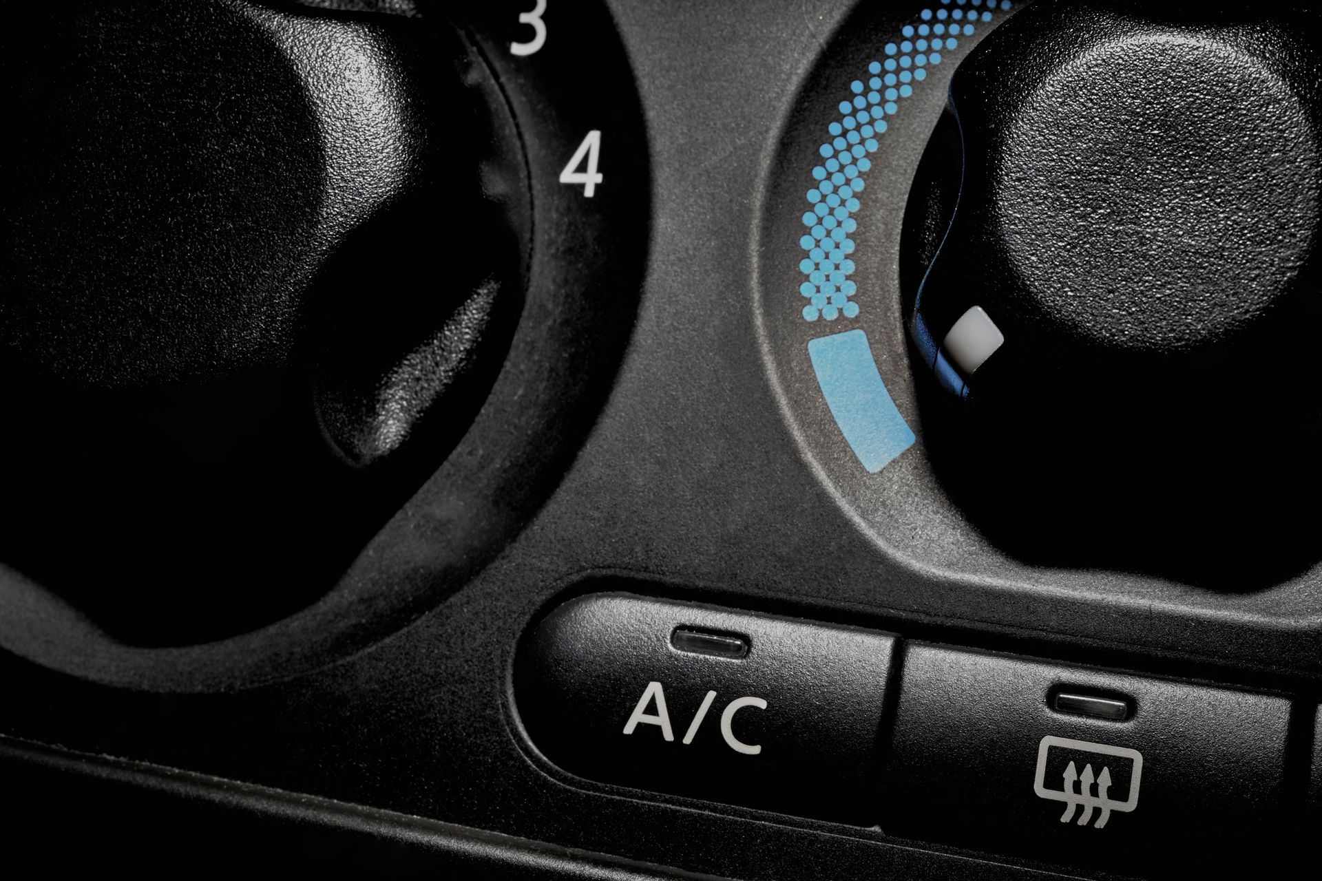 A close up of a car a/c control panel