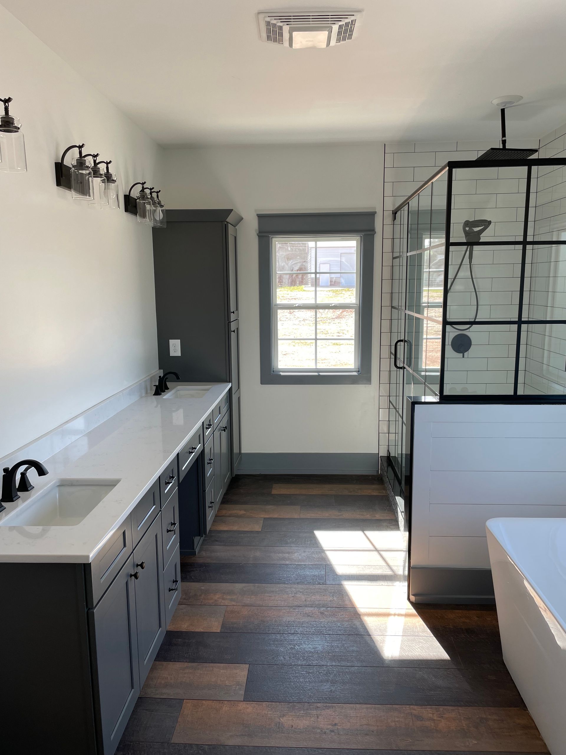 A bathroom with a sink , tub and shower.