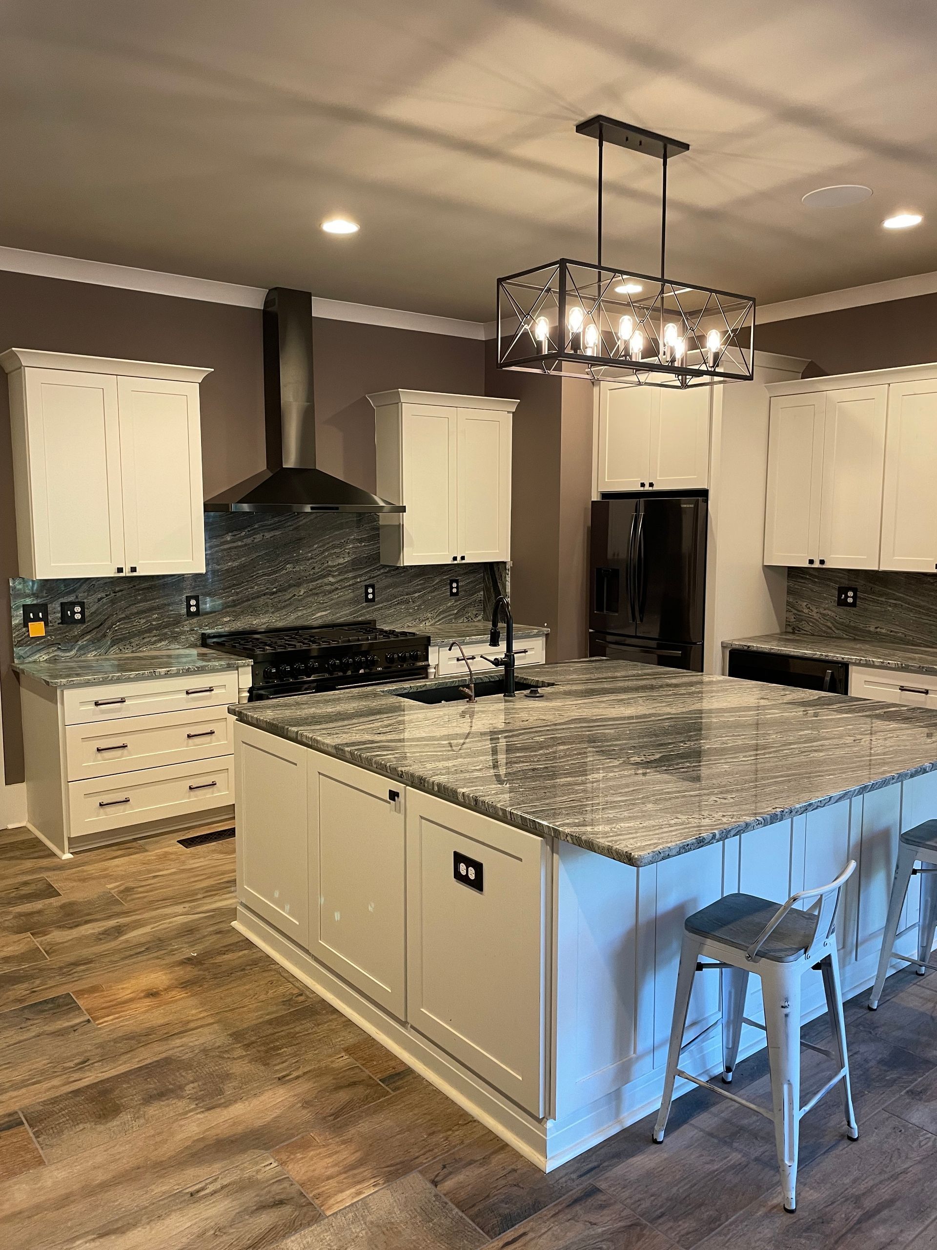 A kitchen with white cabinets and granite counter tops