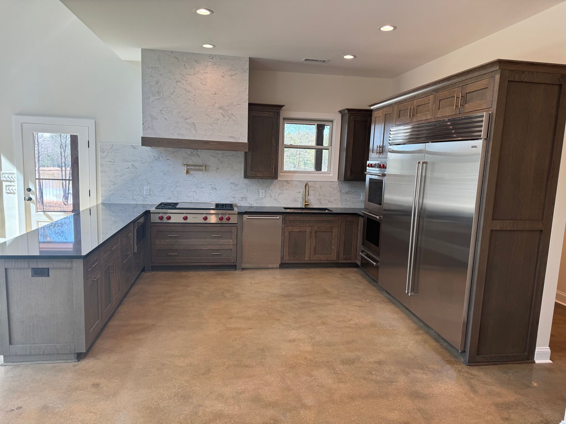 A kitchen with stainless steel appliances and wooden cabinets