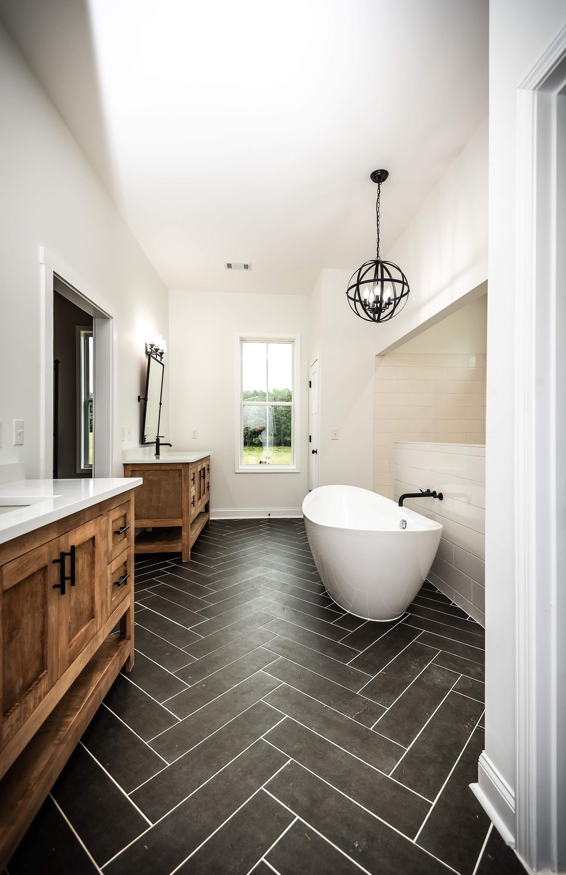A bathroom with a bathtub and two sinks.