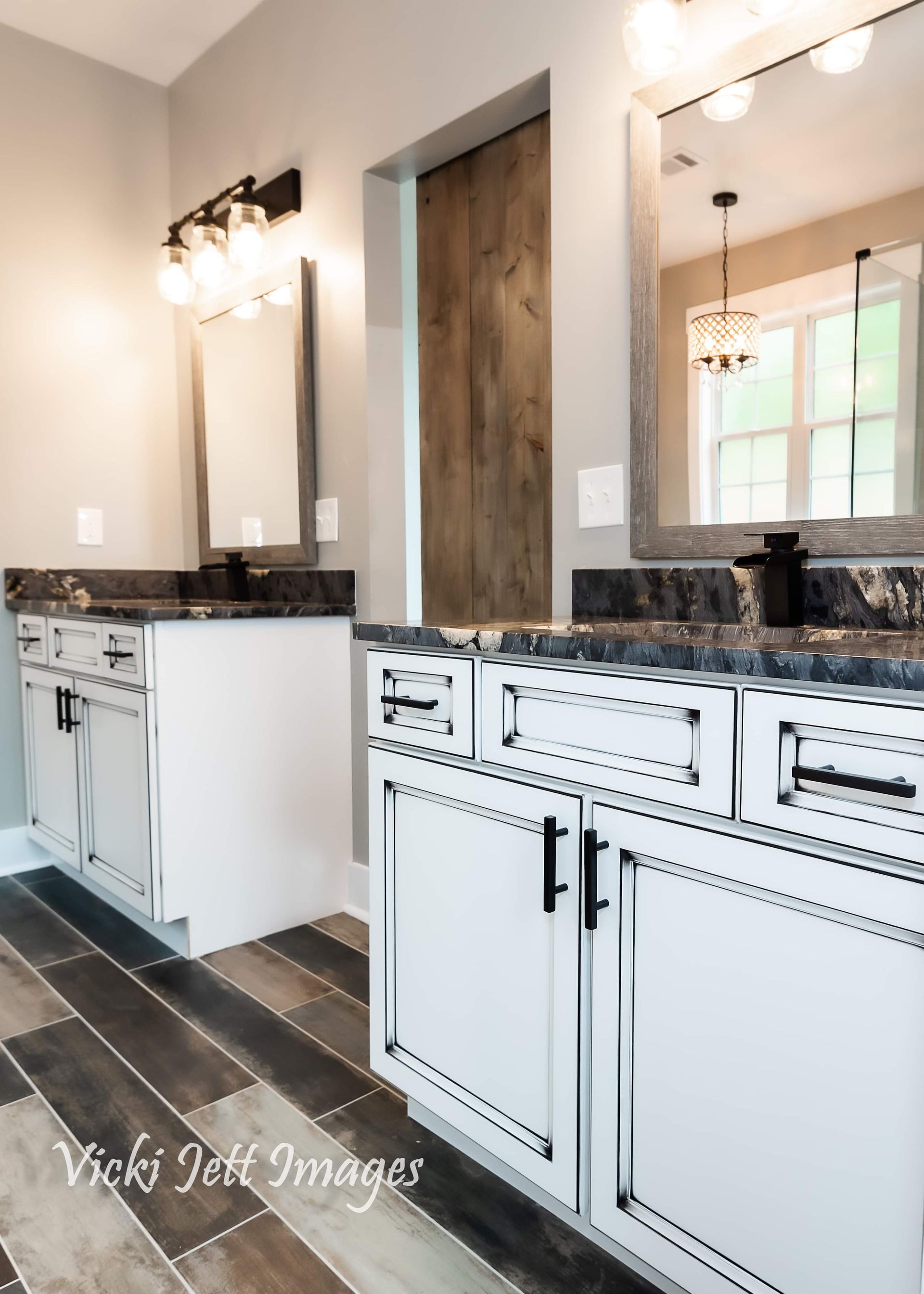 A bathroom with two sinks and two mirrors.