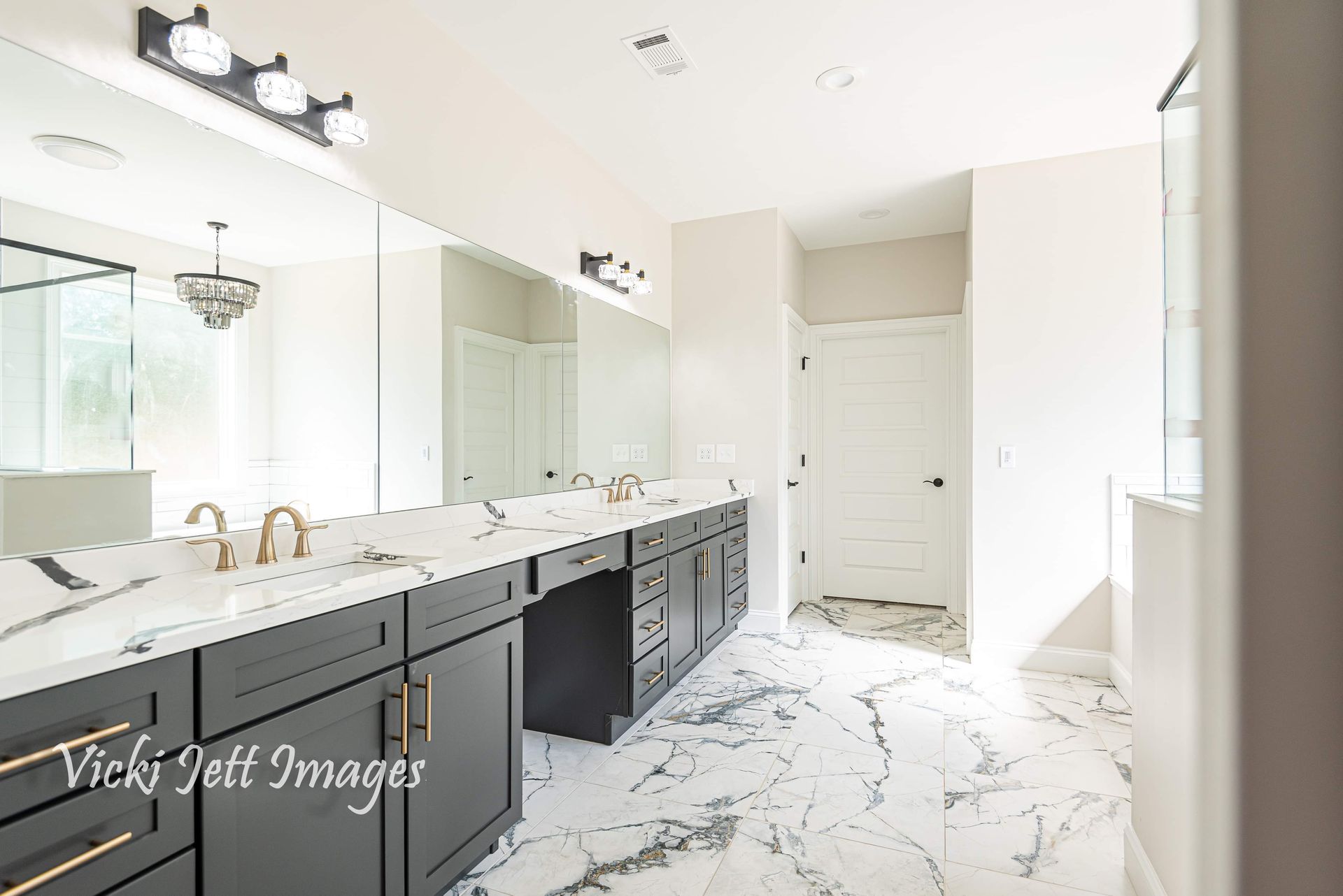 A bathroom with two sinks and a marble floor.