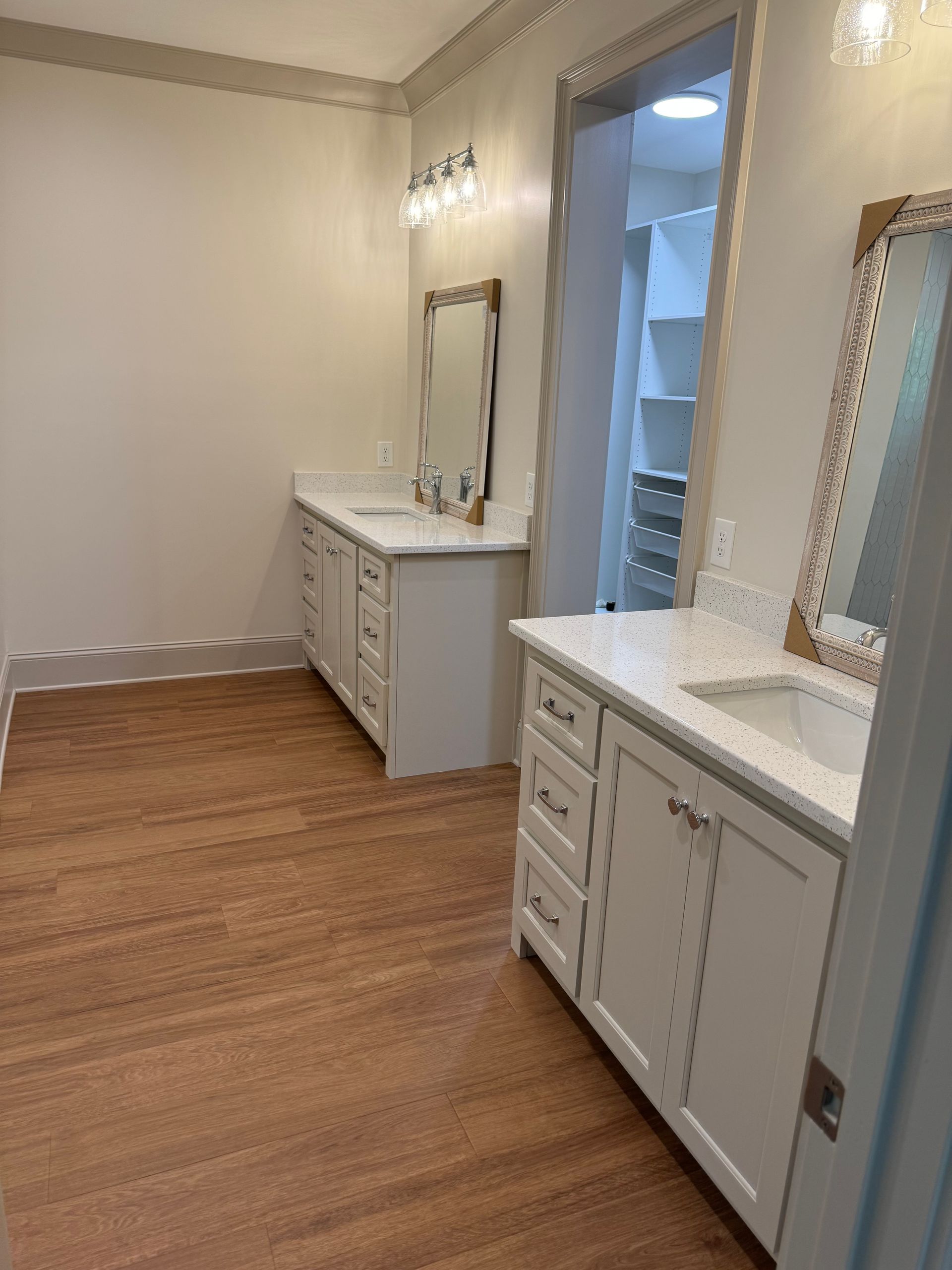 A bathroom with two sinks and a mirror.