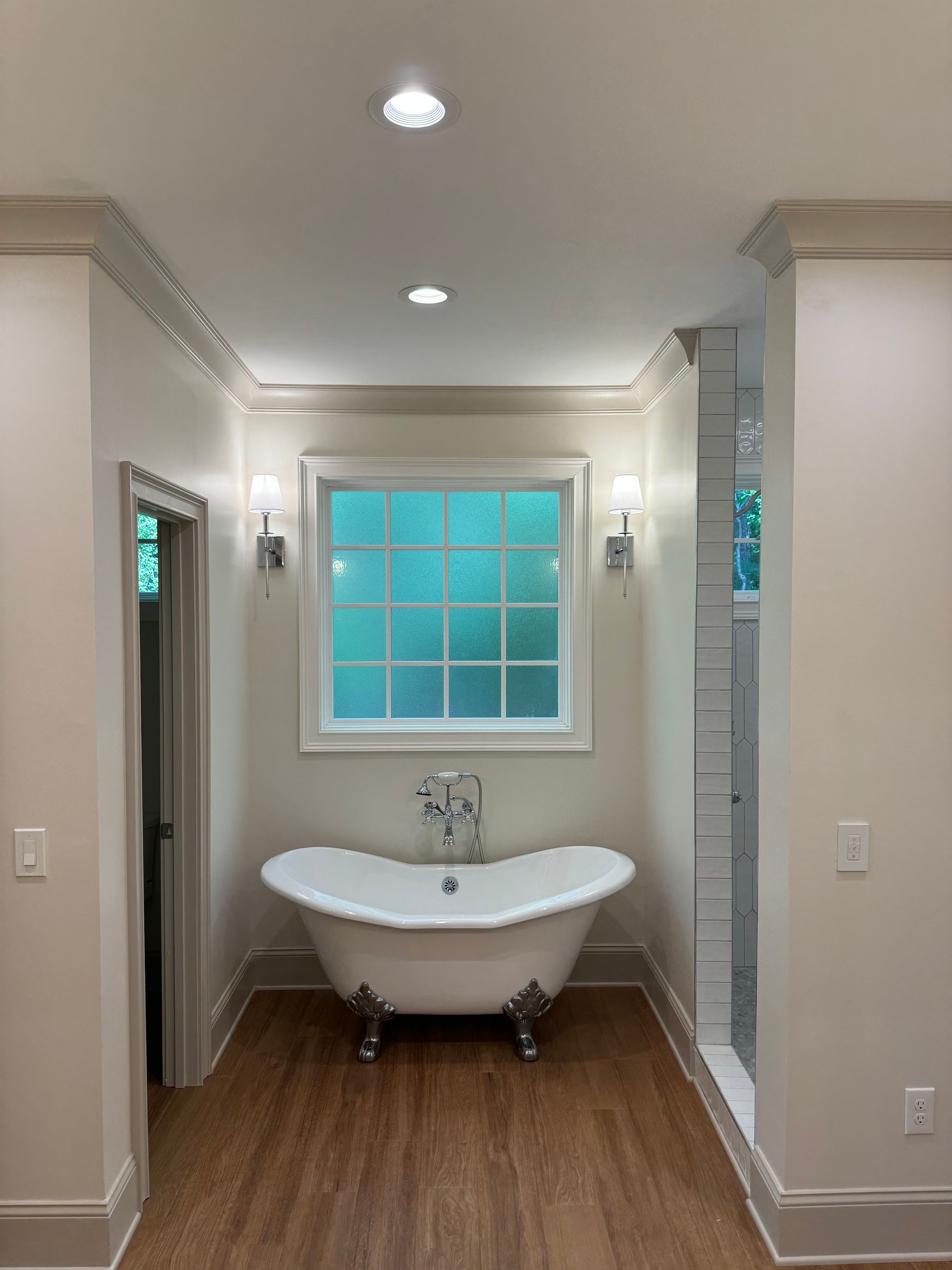 A bathroom with a claw foot tub and a window
