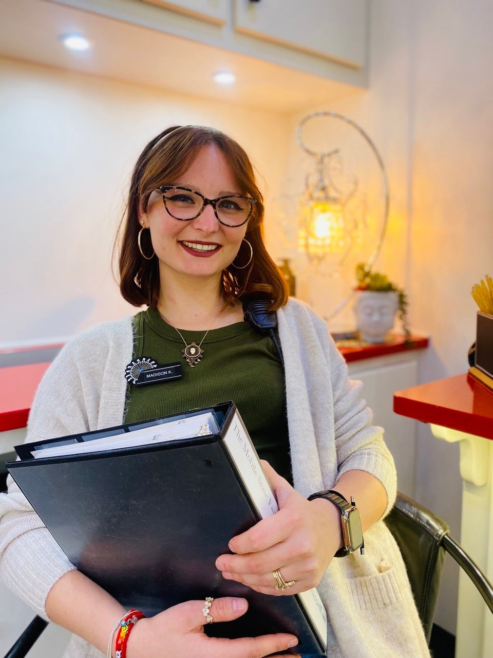 Madison Kissel is holding a folder in her hands.