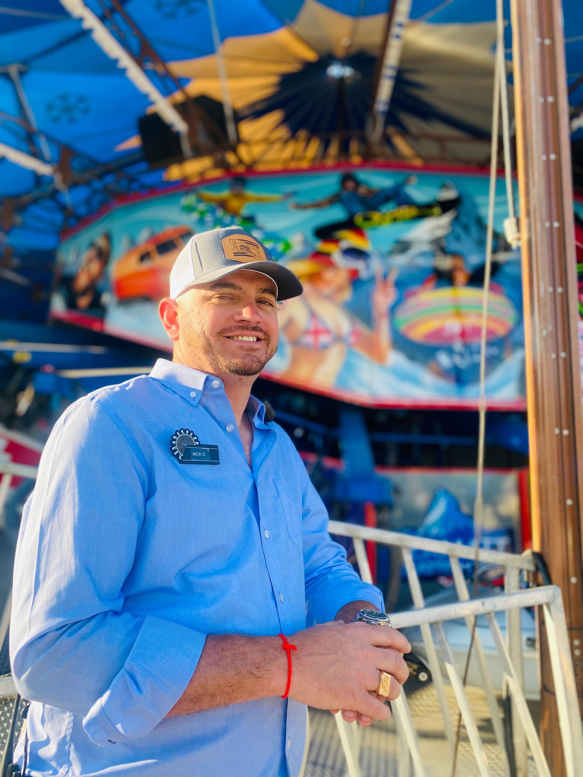 Nick Seibert standing in front of a carousel.