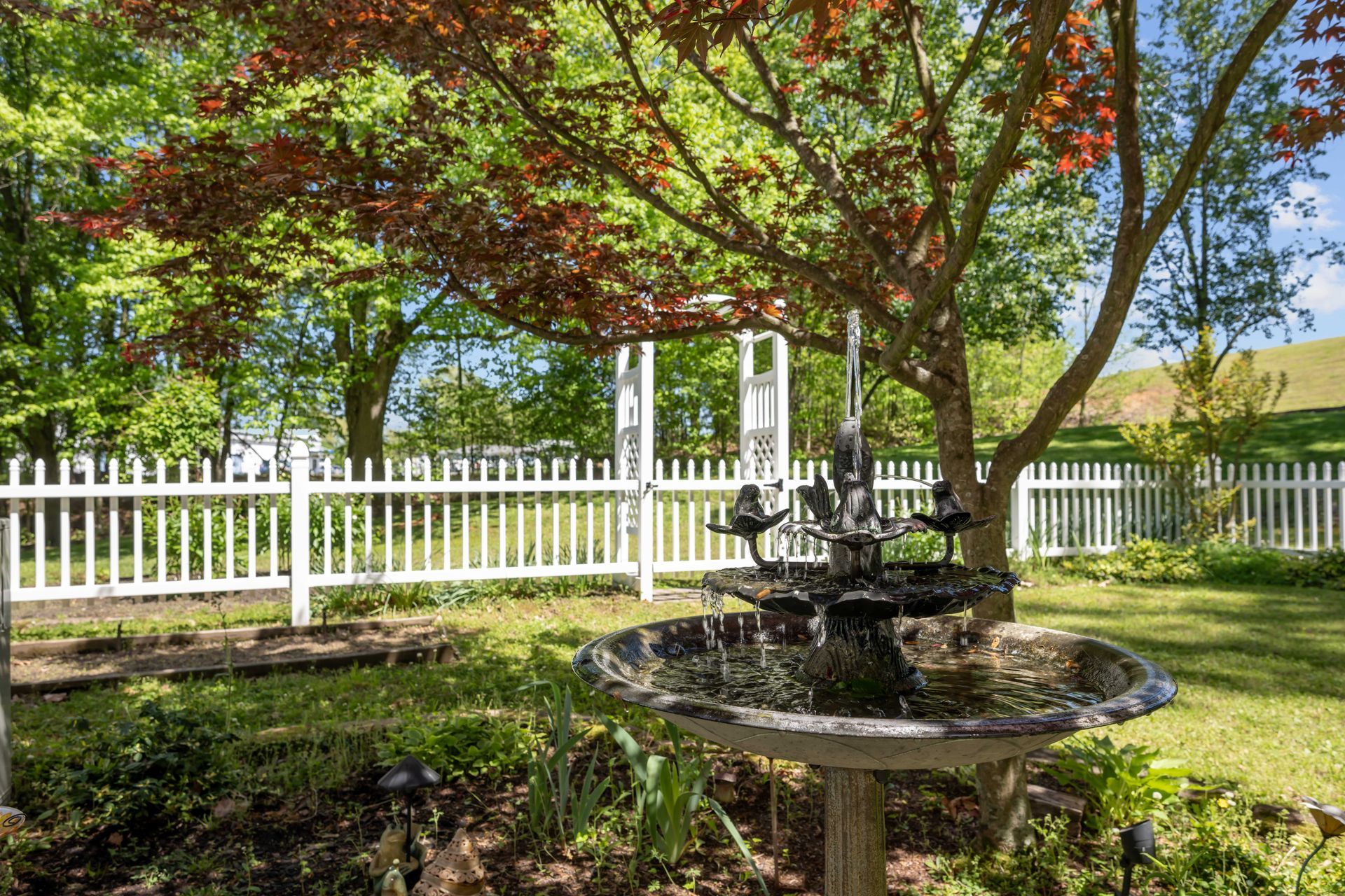 There is a fountain in the middle of the garden.